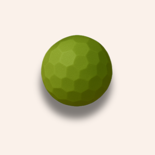 The indented light green ball zoomed in on a pale blush pink background