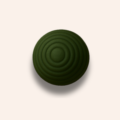 The rippled dark green ball zoomed in on a pale blush pink background